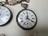 two clocks that are sitting on a table together