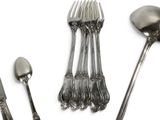 a lot of silver spoons and forks on the table