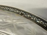 a silver plate with a decorative design on it