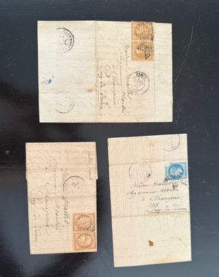 three pieces of old paper with stamps on them on a black surface