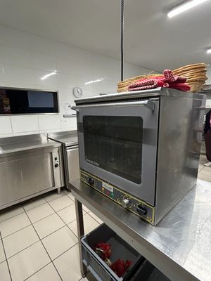 stainless steel counter top in a commercial kitchen with a toaster oven