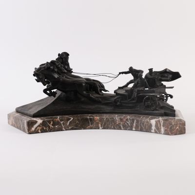 statue of a man on a horse drawn carriage on a marble base