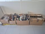 many boxes of shoes sitting on the floor next to each other