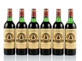 six bottles of wine are lined up on a white surface