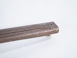a close up of a piece of metal on a white surface