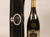 a bottle of wine sitting next to a black box