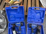 two blue tools are sitting on a pallet next to a pallet