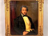 portrait of a man in a tuxedo in a gold frame