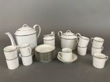 a lot of cups and saucers that are sitting on a table