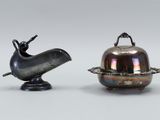 pair of silver plated objects with a bird on top of it