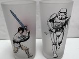 pair of star wars drinking glasses with a stormtrooper and darth vader on them