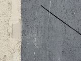 a clock on the side of a building that has a black arrow on it