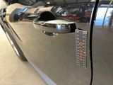 a close up of a car door handle with a sticker on it