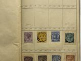 an open book with stamps on it sitting on a table