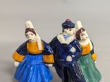 two figurines of people that are standing next to each other