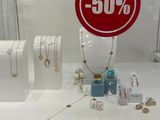 a red sign that says 50 % on it in a display case
