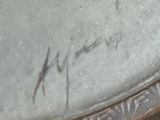 a close up of a clock with writing on it