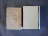 an old book with a picture of a cross on the front and a book with a picture of a cross on the back