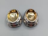 pair of silver and gold earrings on a white surface
