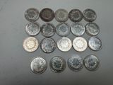 several different types of coins are arranged on a table