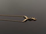 an image of a gold necklace with a bird on it