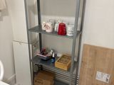 a shelf in the corner of a room with a cup on it