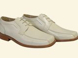 men ' s white dress shoes with brown soles on a white background