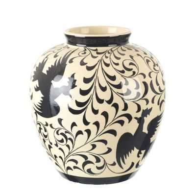 un vase noir et blanc orné d'un motif d'oiseau