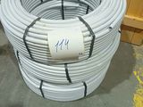 a close up of a coil of white plastic pipes in a warehouse