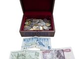 a wooden box filled with money and coins on a white background