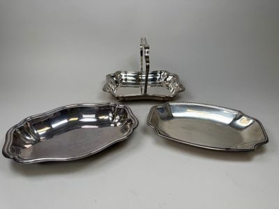 a set of three silverplated dishes on a stand