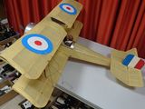 a model of a plane made out of cardboard on a table