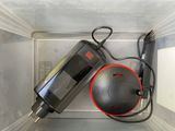 un objet noir et rouge dans un récipient en plastique