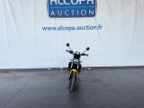 a motorcycle that is parked in front of a sign