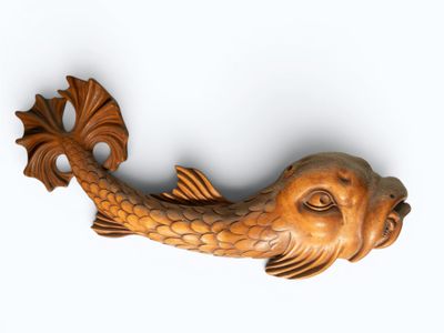a wooden fish that is hanging on the wall
