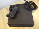 a video game console and a charger on a table