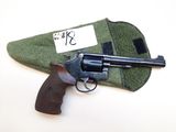 gun in a case with a tag on it sitting on a table