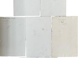 several pieces of paper are stacked on top of each other on a white surface