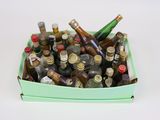 many bottles of alcohol in a box on the table
