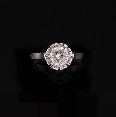a close up of a diamond ring on a black surface