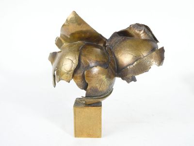 a bronze sculpture of a flower on a wooden base