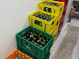 several crates of soda are lined up against a wall in a store