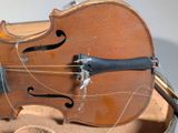 a violin that is sitting in a case on a table