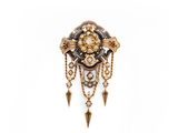 a close up of a broochle with a clock on it