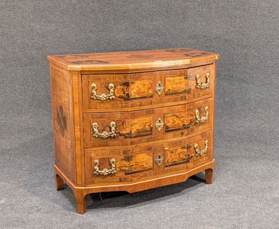 an antique chest of drawers with a wooden top and brass handles