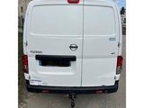 the back end of a white van parked in a parking lot