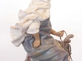 a figurine of a woman riding a camel