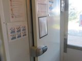 a white refrigerator in the corner of a room