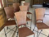 six chairs in a room with wood paneled walls and a black chair