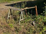 a broken gate sitting in the middle of a field